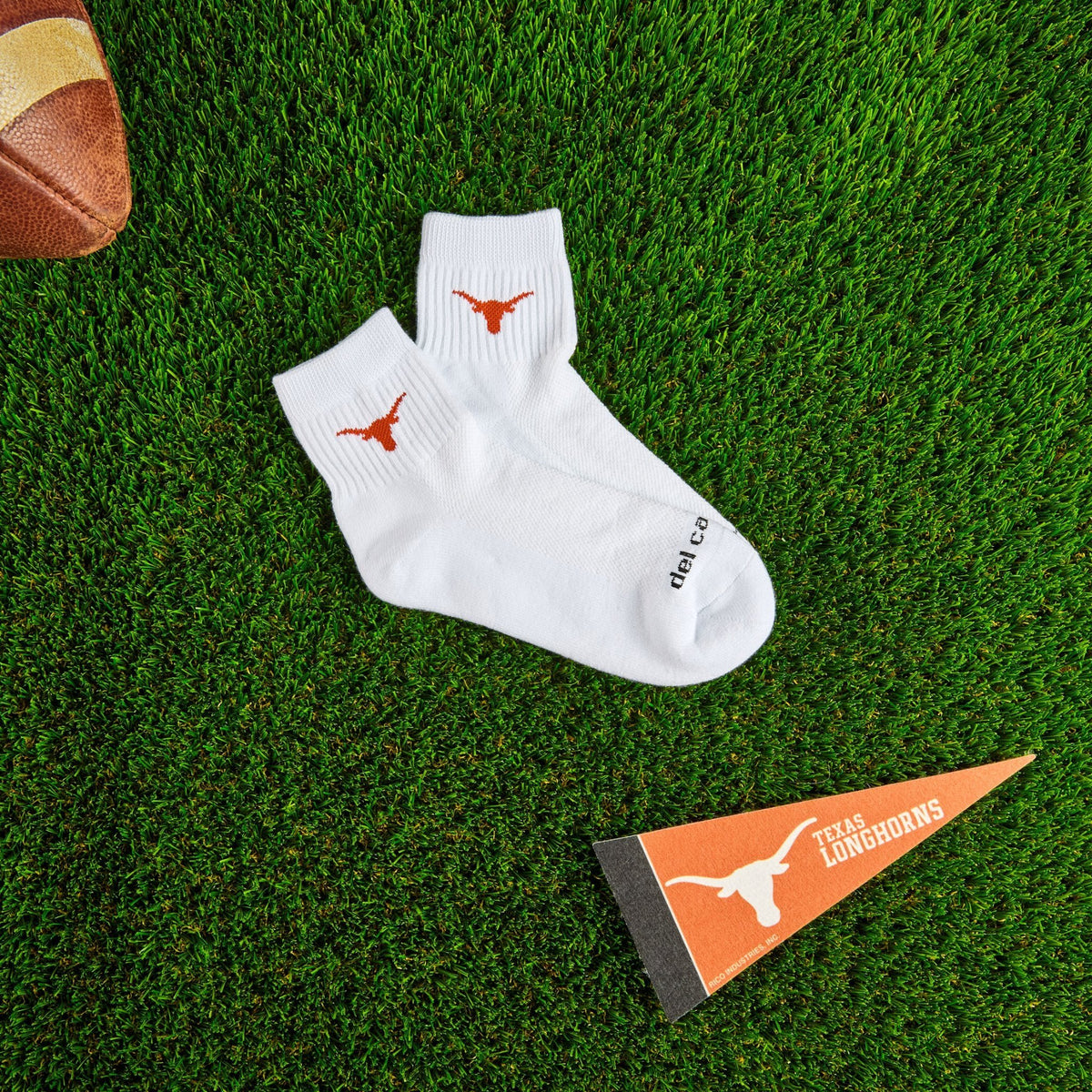 Del Campo Texas Longhorns golf socks on turf with a team pennant