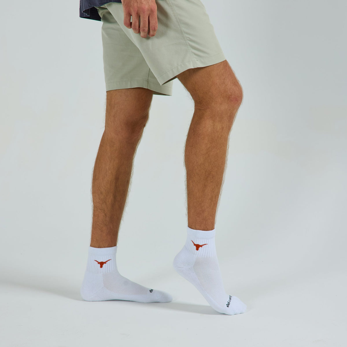 Man wearing Del Campo Texas Longhorns golf socks, studio shot, no shoes