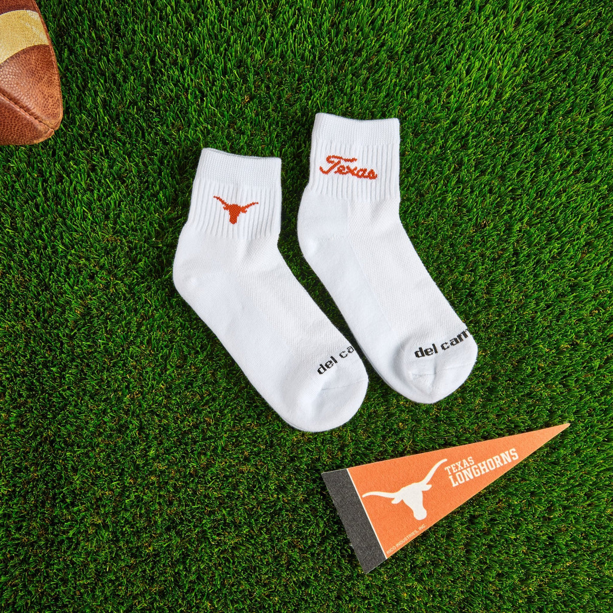 Flat lay of Del Campo Texas Longhorns Pack golf socks with game-day props