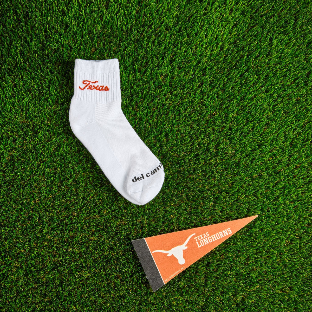 Del Campo Texas Longhorns Script golf socks on turf with a team pennant