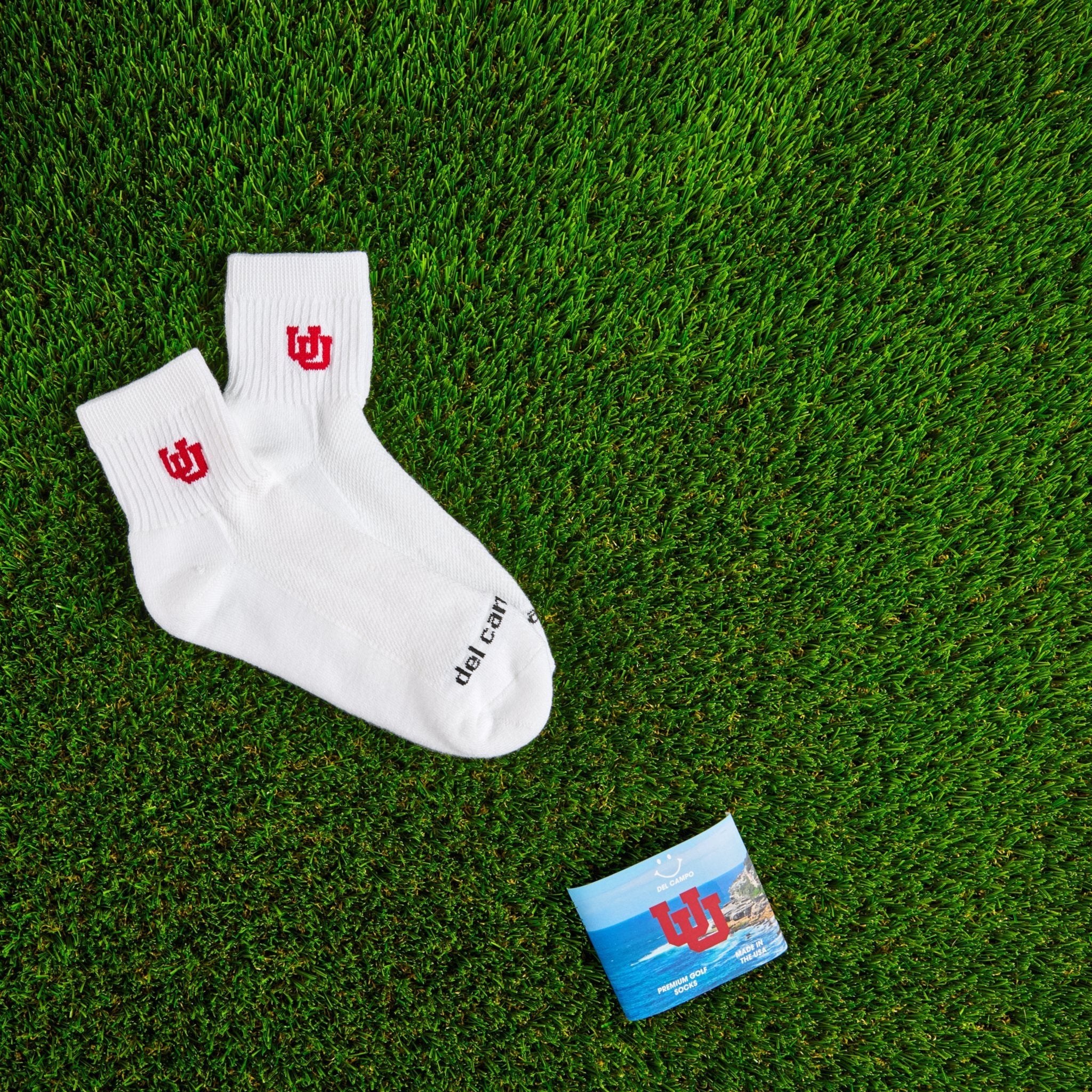 Del Campo Utah Utes golf socks on turf with a team pennant