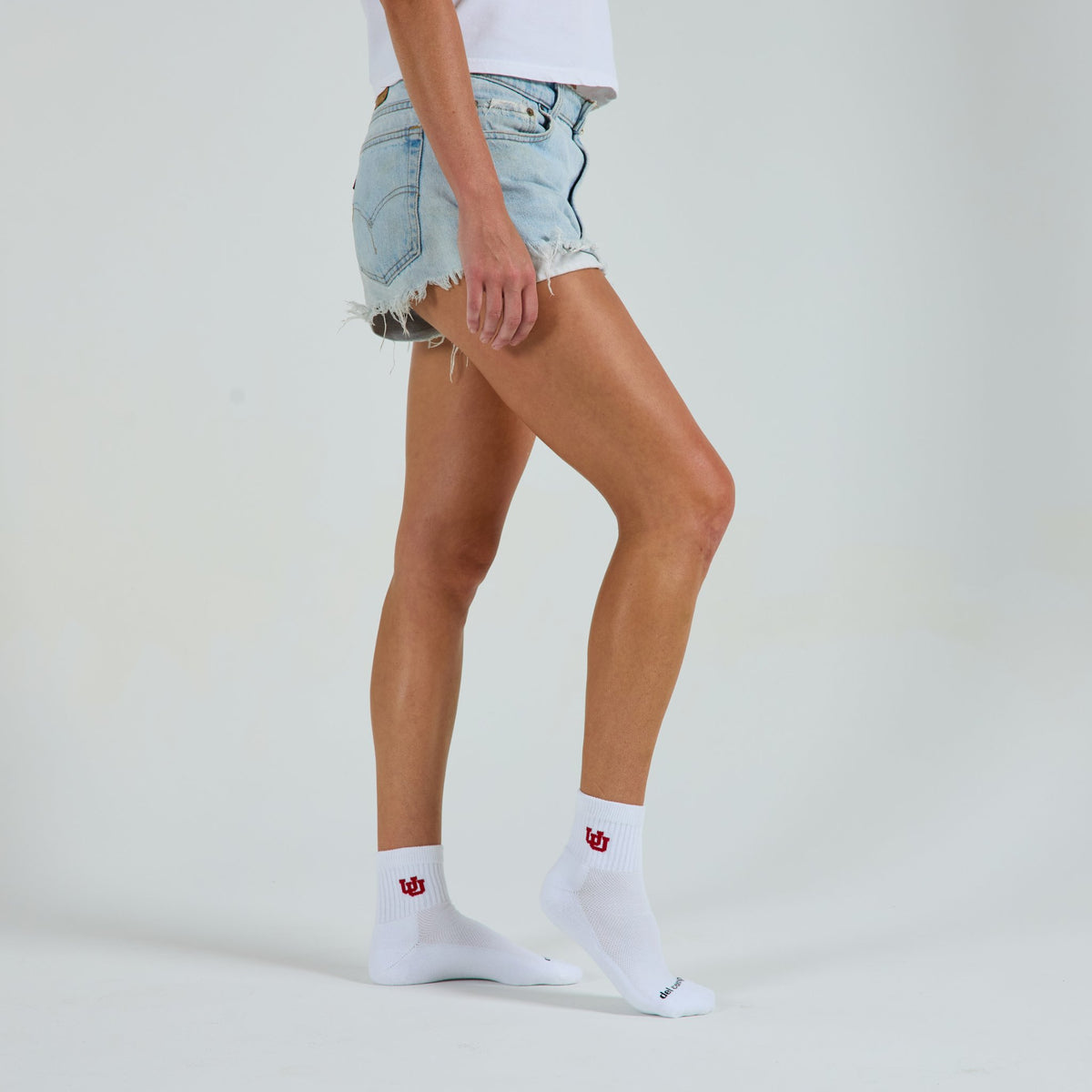 Woman wearing Del Campo Utah Utes golf socks, studio shot, no shoes