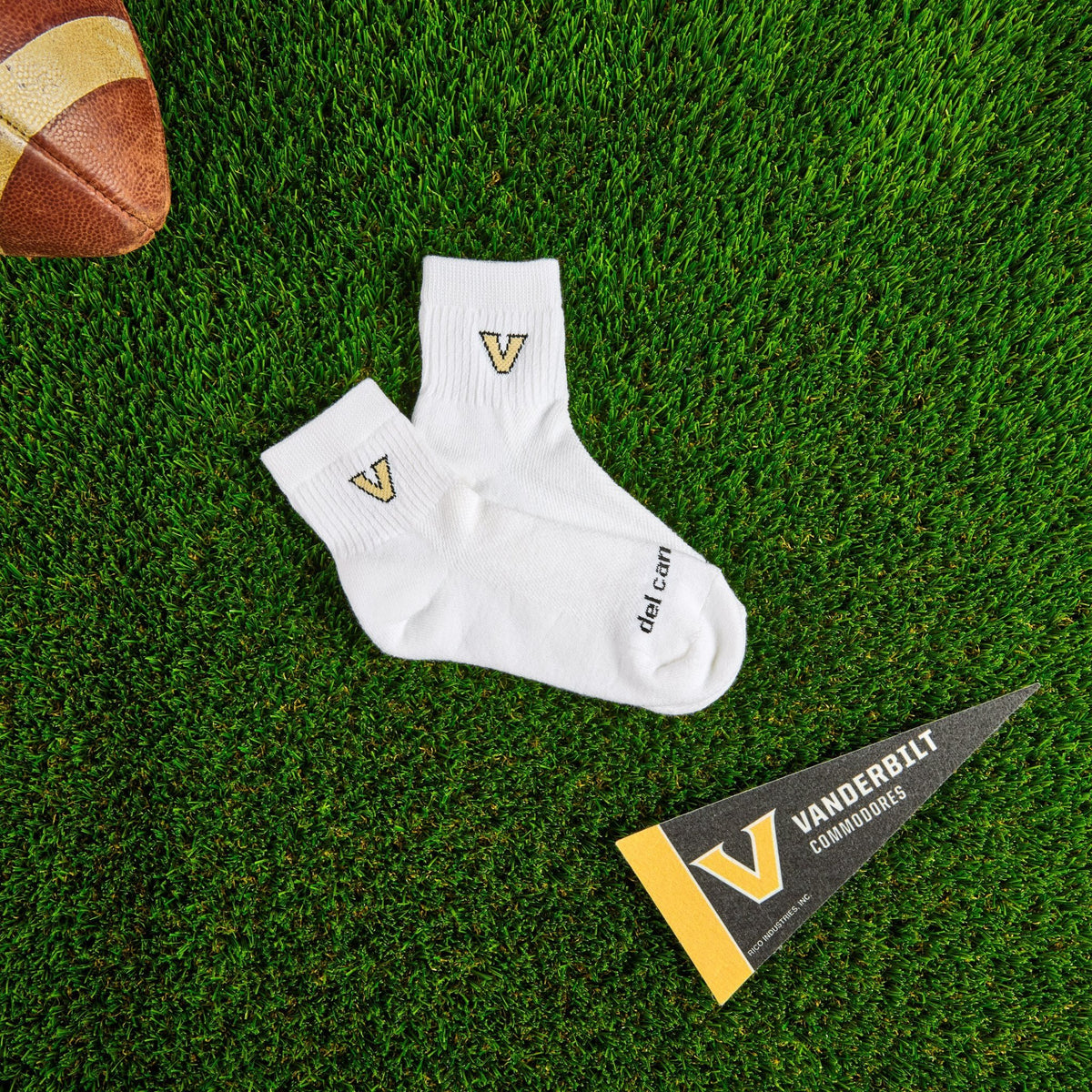 Del Campo Vanderbilt Commodores golf socks on turf with a team pennant