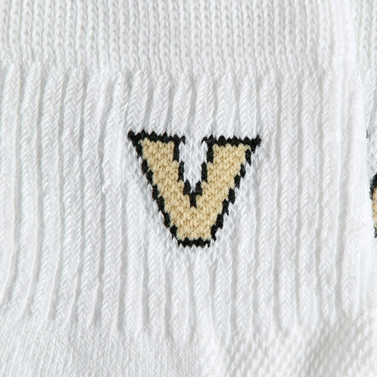 Close-up of the gold V on Del Campo Vanderbilt Commodores golf socks