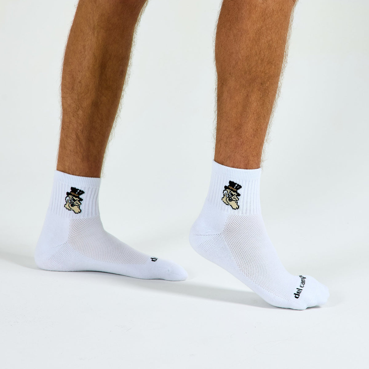Man wearing Del Campo Wake Forest Demon Deacons golf socks, studio shot, no shoes