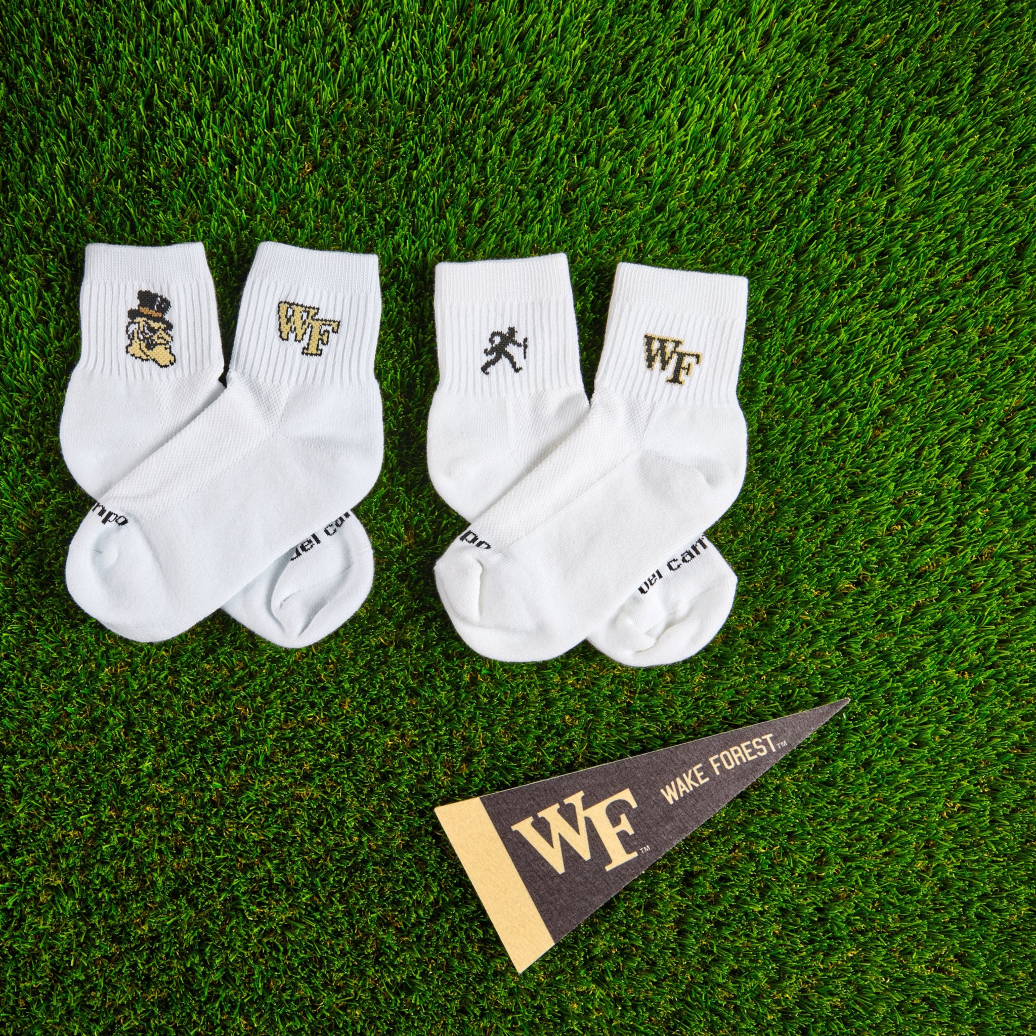 Del Campo Wake Forest Pack golf socks on turf with a team pennant