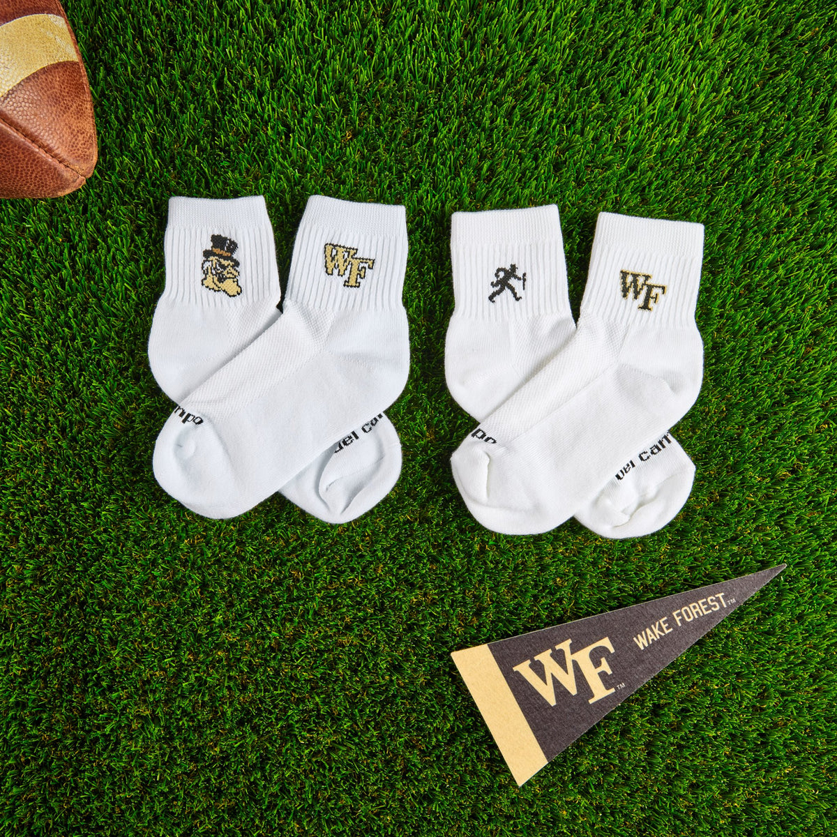 Del Campo Wake Forest Pack golf socks on turf with a team pennant