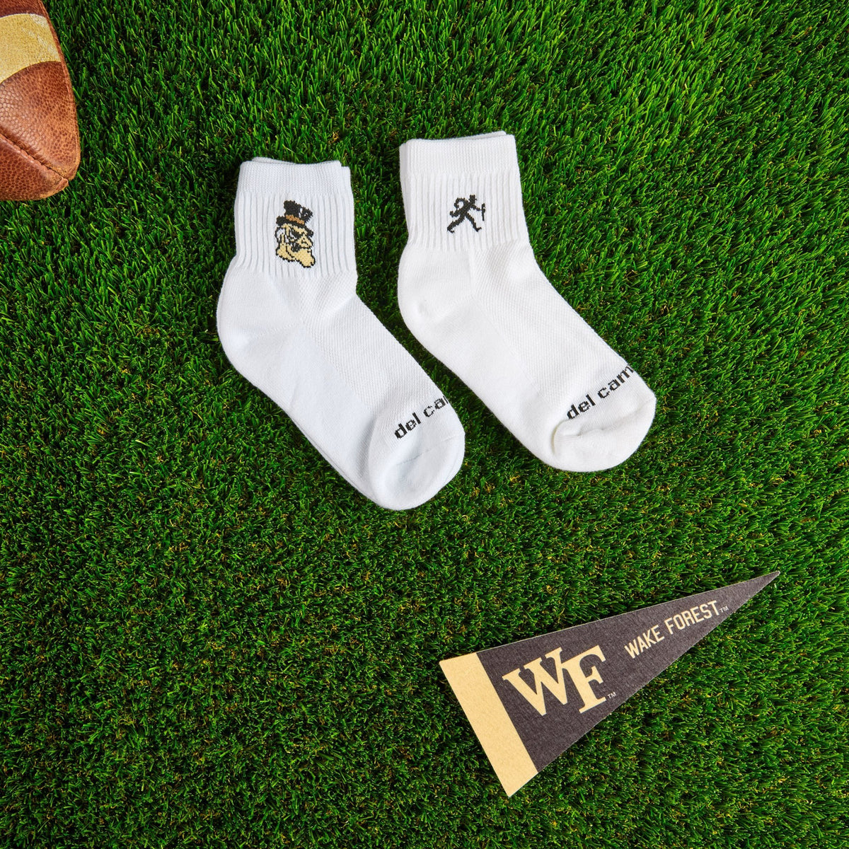 Flat lay of Del Campo Wake Forest Pack golf socks with game-day props