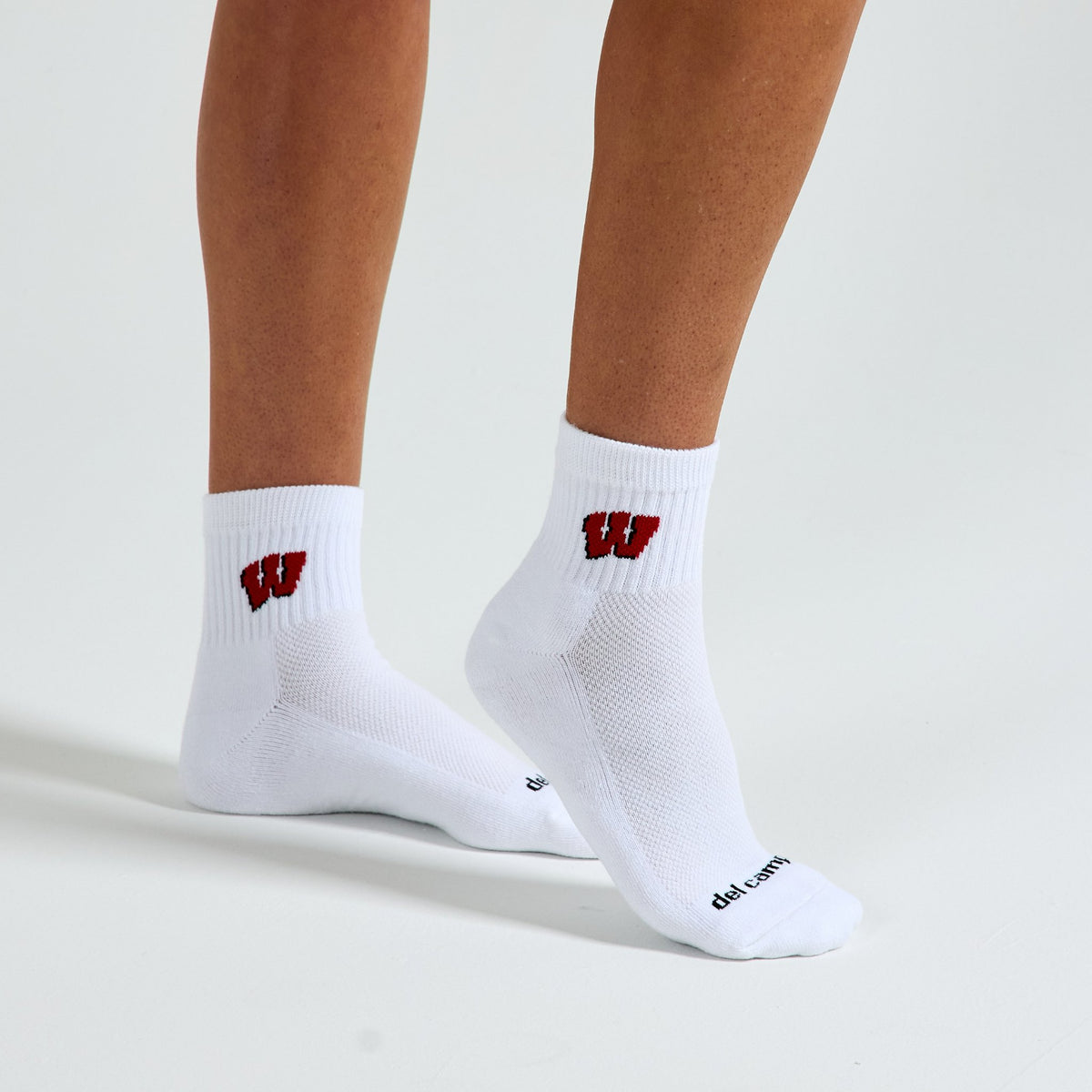 Woman wearing Del Campo Wisconsin Badgers golf socks, studio shot, no shoes