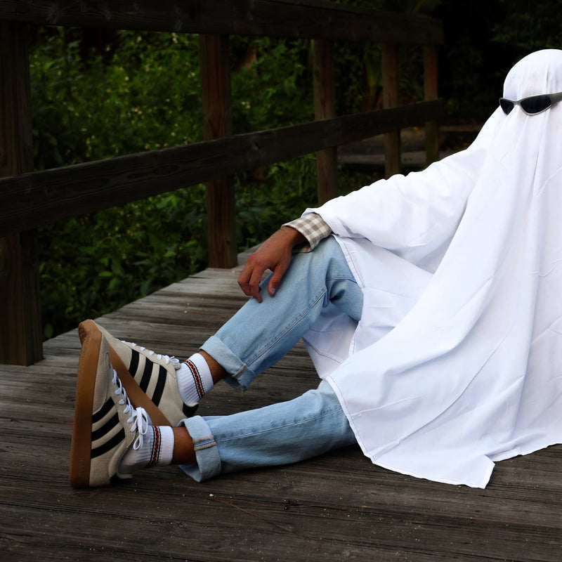 Ghost in sunglasses on a boardwalk wearing Halloween socks