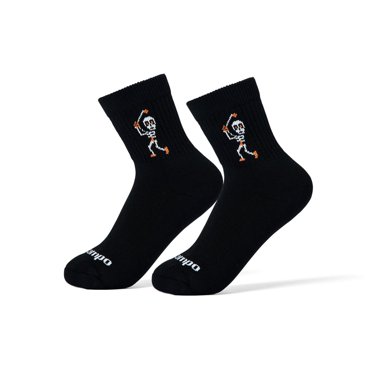Del Campo Swingin' Skelly Halloween golf socks, black quarter socks with a skeleton golfer mid-swing in white and orange, pair on sock forms